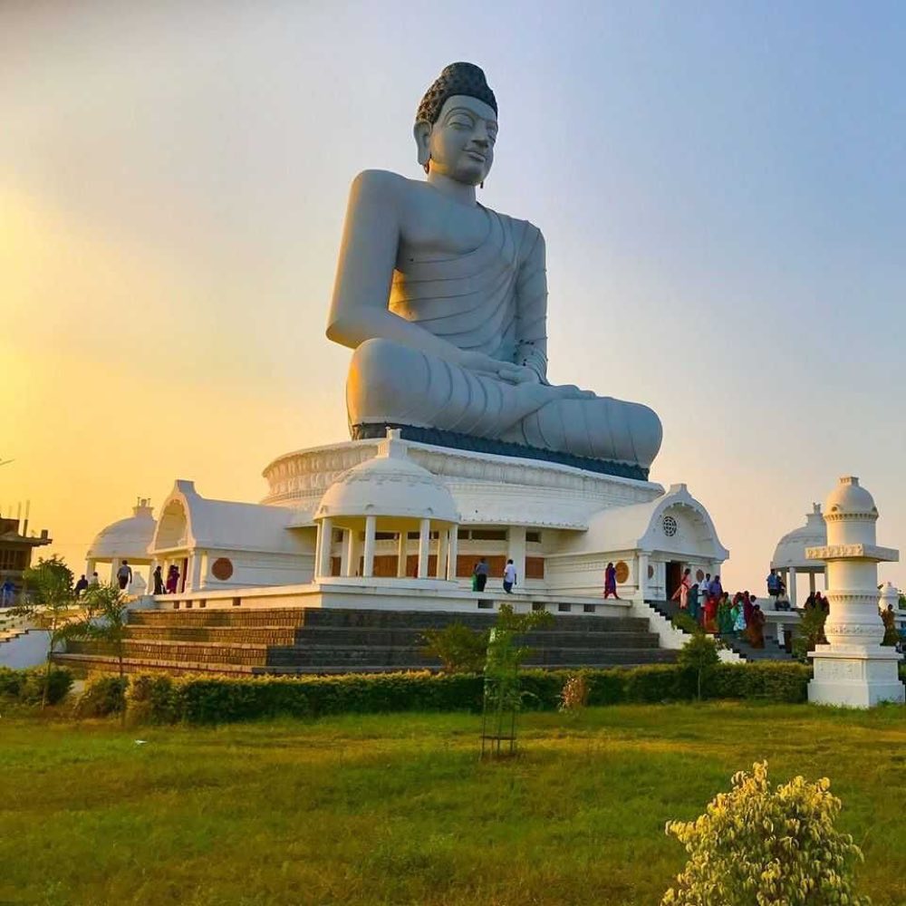 A colossal white seated Buddha above its pavilion at sunset, Andhra Pradesh